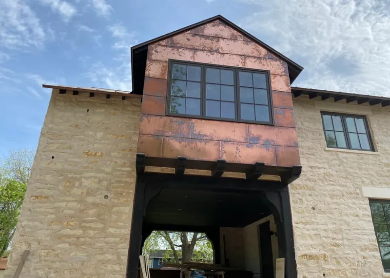 Copper metal panel facade on a stone building for Skylight Installation in Indian Hills