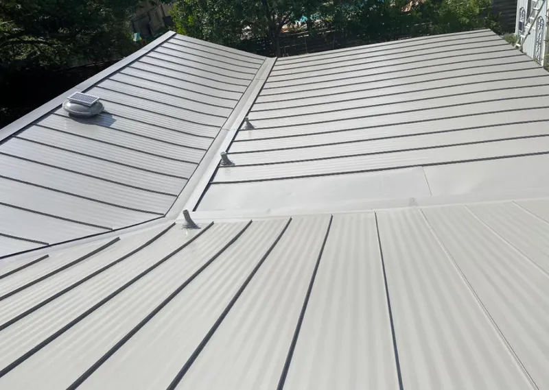 Solar attic fan installed on a metal roof for Roof Ventilation in Indian Hills